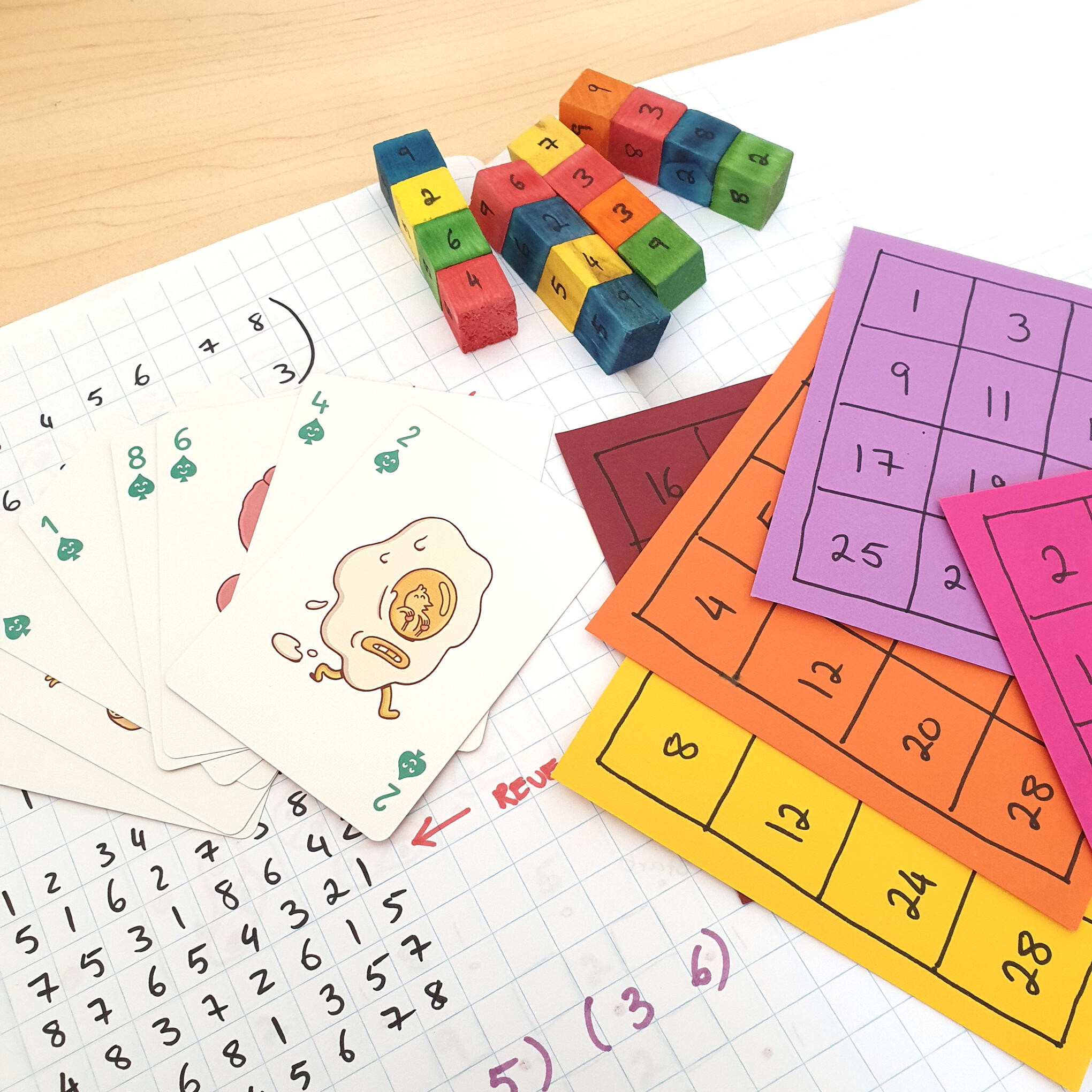 Dice, playing cards and number grids used in maths magic tricks exploring binary numbers and logical reasoning